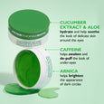Green gel eye patches in white container with lid open, showing translucent patches and ingredient callouts.