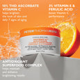 White jar with orange band labeled Potent-C Brightening Vitamin C Moisturizer surrounded by water splashes and citrus fruit o