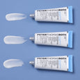Three tubes of Peter Thomas Roth acne treatment gel with blue accents and white cream swatches on blue background.
