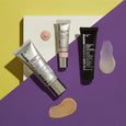 Three Peter Thomas Roth Instant FIRMx skincare tubes in silver and black packaging displayed with product swatches on yellow 