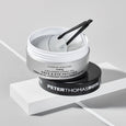 Open jar of FIRMx Collagen Hydra-Gel Face & Eye Patches with gel patches and black applicator tweezers inside.