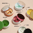 Five open jars of Peter Thomas Roth eye patches in varying colors displayed with benefit labels.