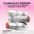 Three metallic cylindrical stick applicators with cream, bronze, and coral-colored tips arranged diagonally on pink backgroun
